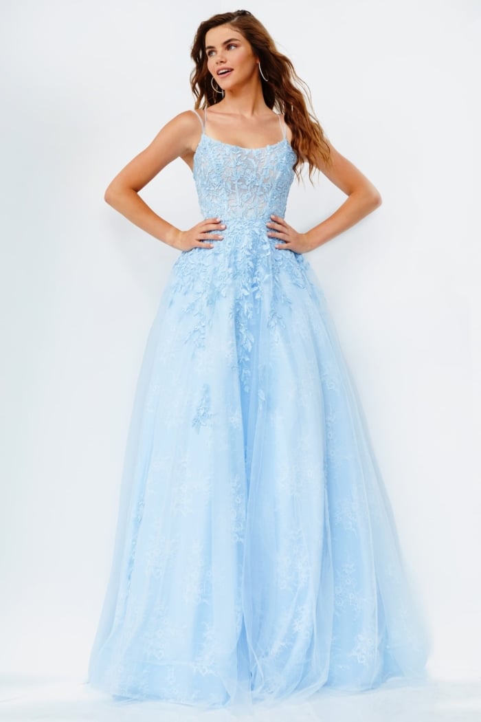 Model in a blue Jovani 06644 gown with delicate embroidery.