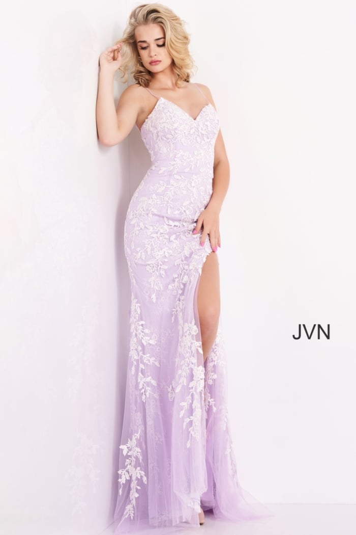 Model wearing Jovani 06660 lilac dress with a high slit and floral details.