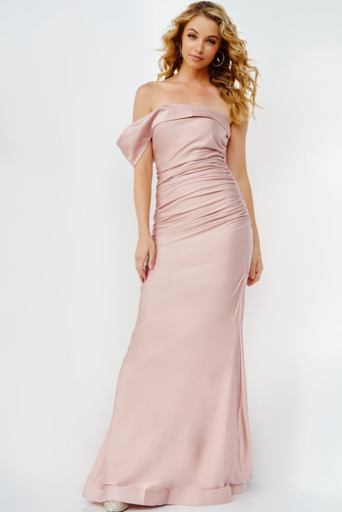 back view of model wearing Jovani 07640 in blush with off-the-shoulder neckline and floor-length design