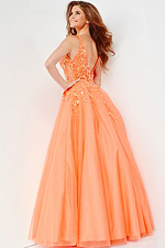 Back view of model in Jovani 22831 orange gown showcasing detailed embroidery