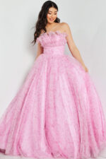Model wearing Jovani 26209 pink gown with ruffled off-the-shoulder neckline.