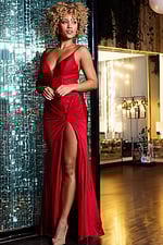 An elegant red dress by Jovani 38817 on model with striking high slit