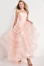 Model wearing Jovani K02442 pink dress with layered tulle skirt, front view.