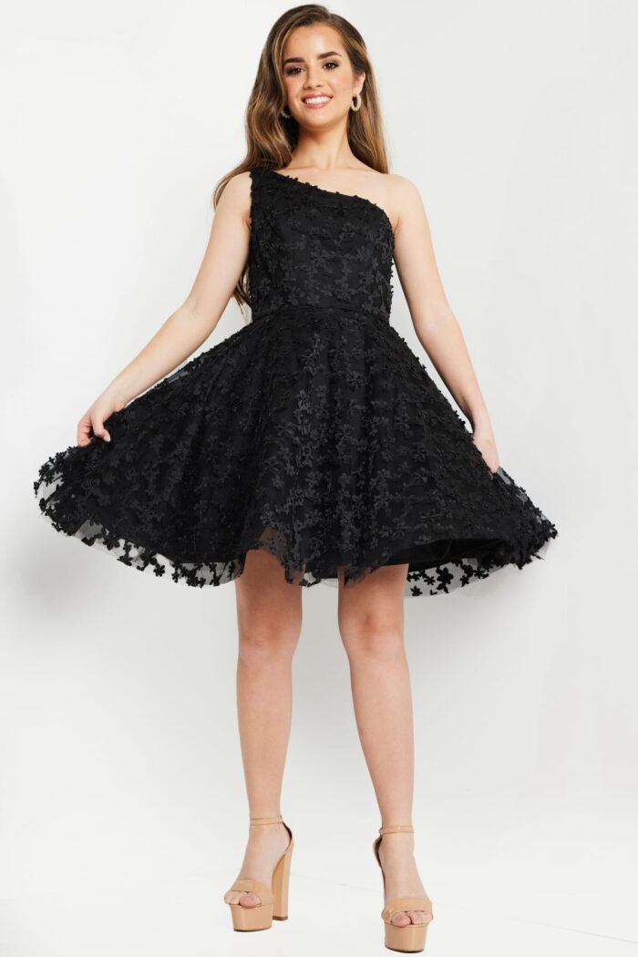 model wearing K23516 black dress in a front pose, highlighting neckline and appliqués.