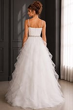 back view of white ruffled ball gown with beaded belt and full organza skirt