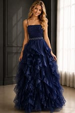 Navy ball gown with lace bodice, spaghetti straps, ruffled tulle skirt, and jeweled waist.
