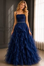 Navy prom gown with lace top, thin straps, and voluminous ruffle skirt.