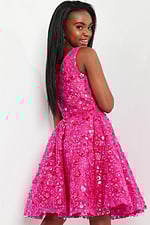 model wearing K23682 fuchsia dress showing back view with floral detailing