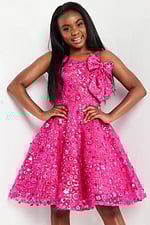 model wearing K23682 fuchsia dress with floral embellishments and shoulder bow, full front view