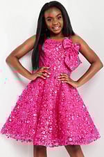 model wearing K23682 fuchsia dress with floral embellishments and shoulder bow, close front view