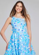 Close-up of K23877 vibrant multi-colored dress worn by model, highlighting playful polka dots.