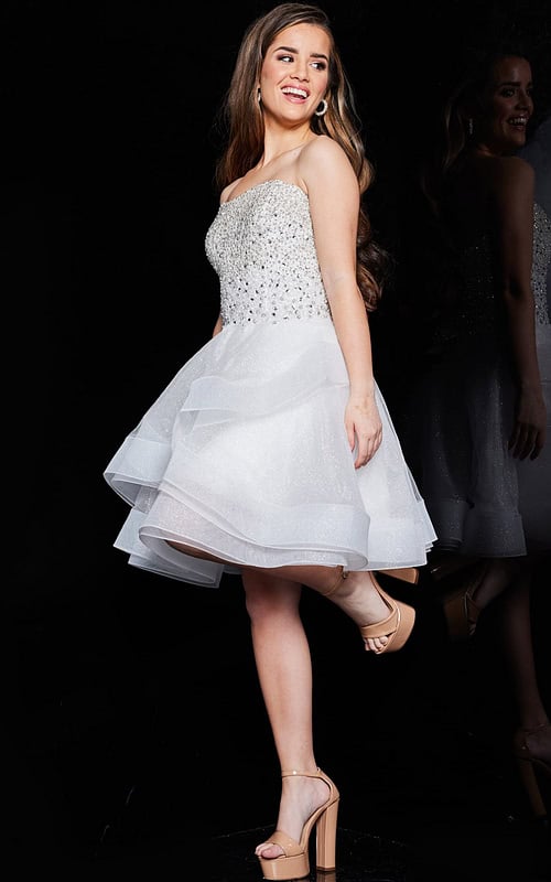 Model wearing Jovani K24050 ivory short dress in front view.