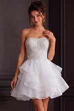 Model wearing Jovani K24050 ivory dress with embellished bodice, front view.