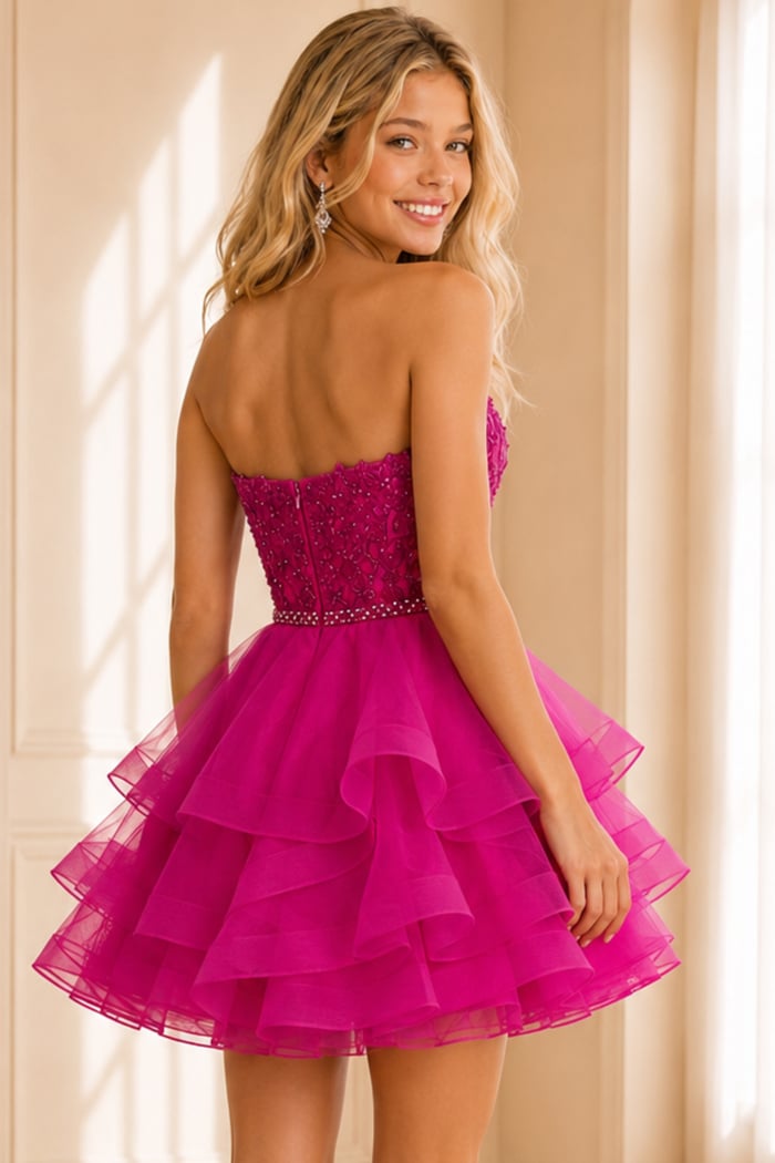 back view of fuchsia ruffle dress with lace bodice and beaded belt