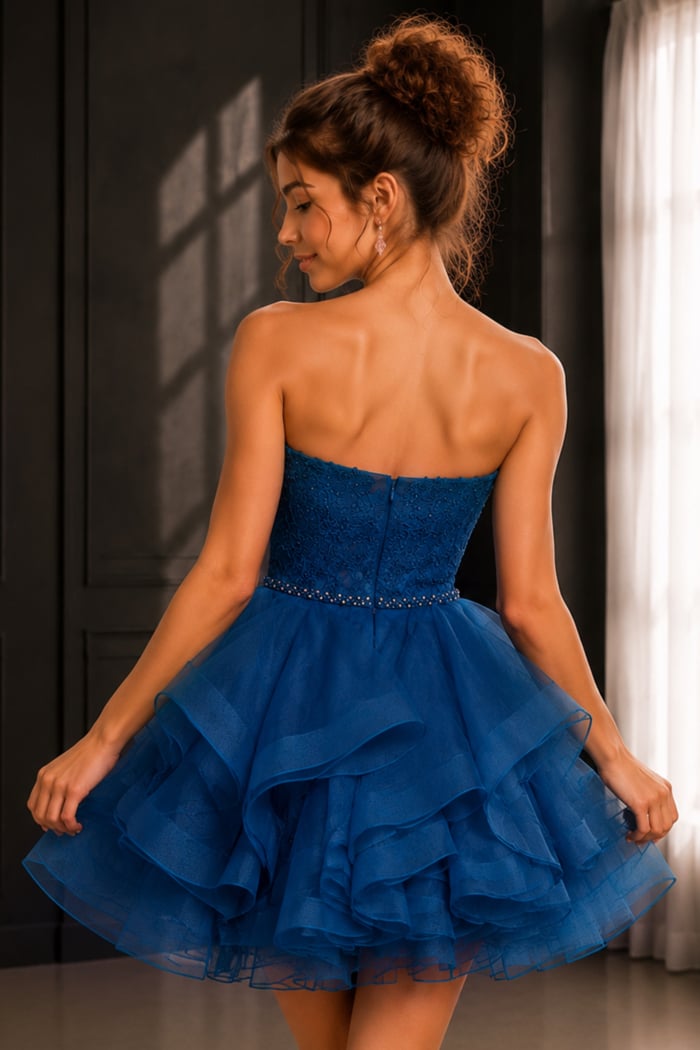 back view of royal blue dress with lace bodice and tiered ruffle skirt