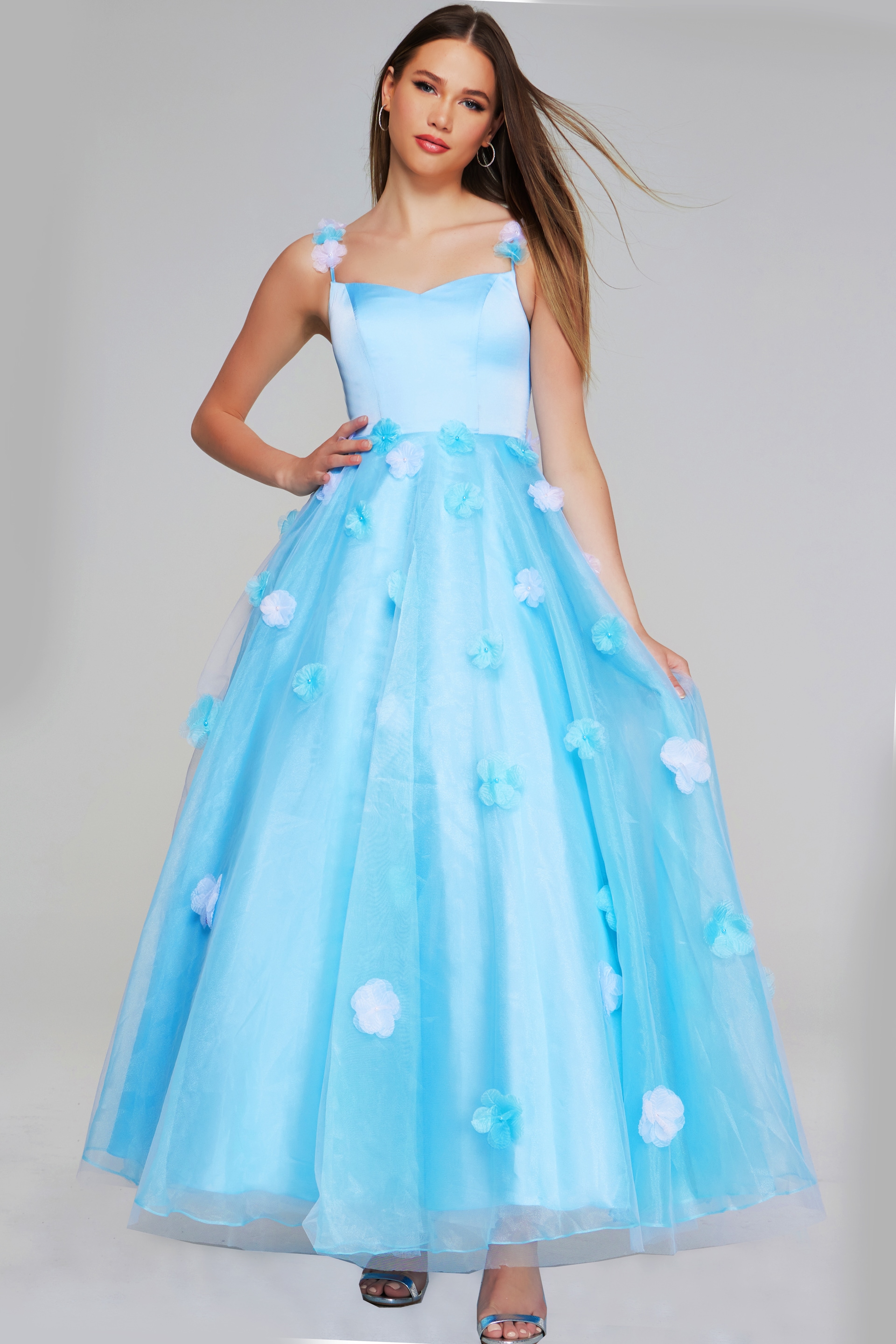 K25988-LIGHTBLUE-207.jpg Model wearing Jovani K25988 light blue gown with floral appliques, front view.