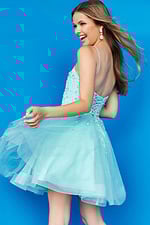 Model showing the back of Jovani K3641 blue dress with corset-style lace-up
