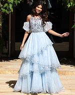Jovani K42178 light blue ball gown with crystal beaded bodice, sheer puff sleeves, and tiered ruffled organza skirt with scattered rhinestone accents