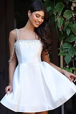 Jovani K48024 pink satin short fit and flare dress back view showing open back with crystal embellished straps, draped rhinestone arm chains, and pleated skirt