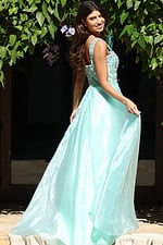 Jovani K48130 mint green A line prom dress back view showing beaded embellished square back bodice with wide straps and flowing organza skirt