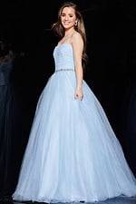 Model wearing Jovani K66712 blue ball gown with flowing tulle skirt.