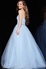 Model wearing Jovani K66712 blue ball gown back view with bead details.