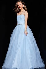 Model wearing Jovani K66712 blue ball gown with full skirt in motion.
