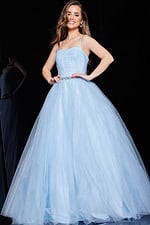 Model in Jovani K66712 blue gown with back view in elegant pose.