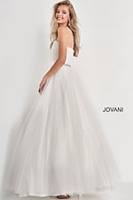 Model wearing Jovani K66712 back view in white showing beadwork.