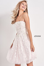 Model in Jovani K68026 white dress, front view with floral designs.