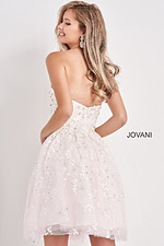 Model showing back view of Jovani K68026 white dress with floral embroidery.