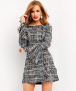 Model wearing Jovani M03273 multi-color tweed mini dress with off-shoulder neckline and fringed details, front view.