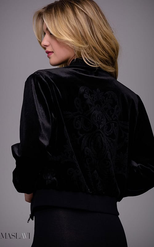 Model wearing M51285 black velvet jacket with floral embroidery from the back.