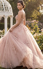 Strapless scoop-neck corset ball gown with a detachable overskirt/train.