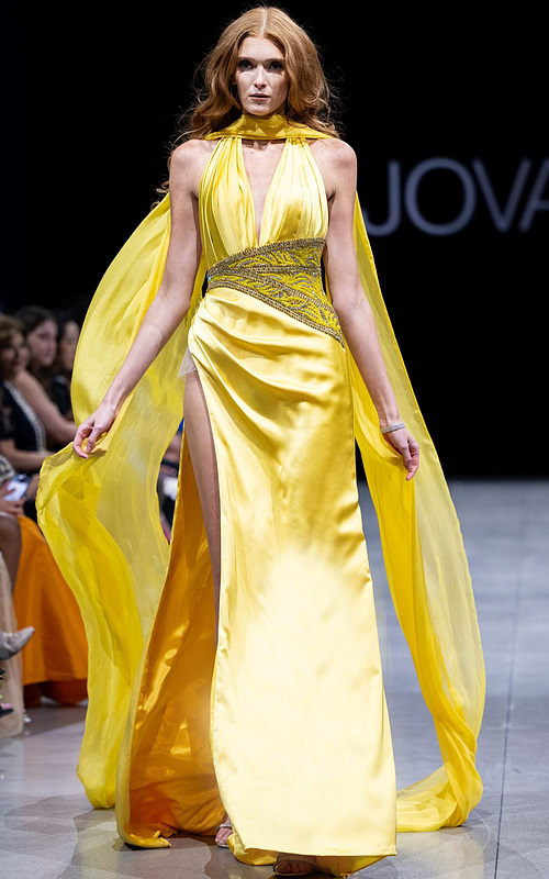 Model wearing S22826 yellow dress with V-neckline and high slit