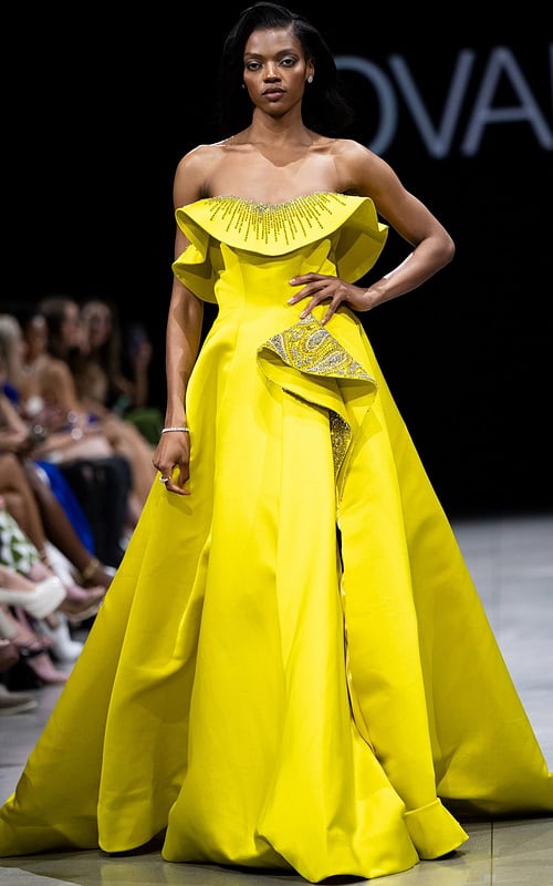 Model wearing Jovani S36369 yellow gown with off-the-shoulder neckline and beaded detail