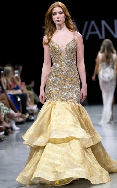 Model wearing Jovani S38449 gold mermaid gown with a plunging V-neckline and layered skirt