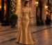 Antique gold metallic wedding guest gown in luxury city setting