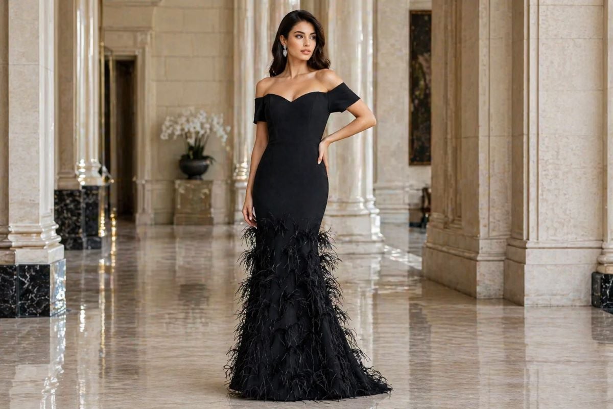 black off-shoulder mermaid gown with feather skirt in luxury interior