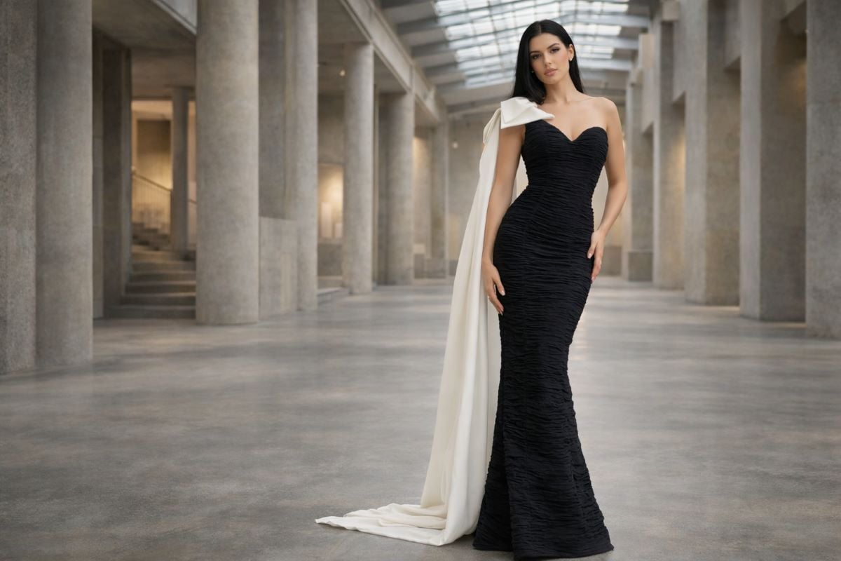 Black strapless ruched mermaid gown with white shoulder drape