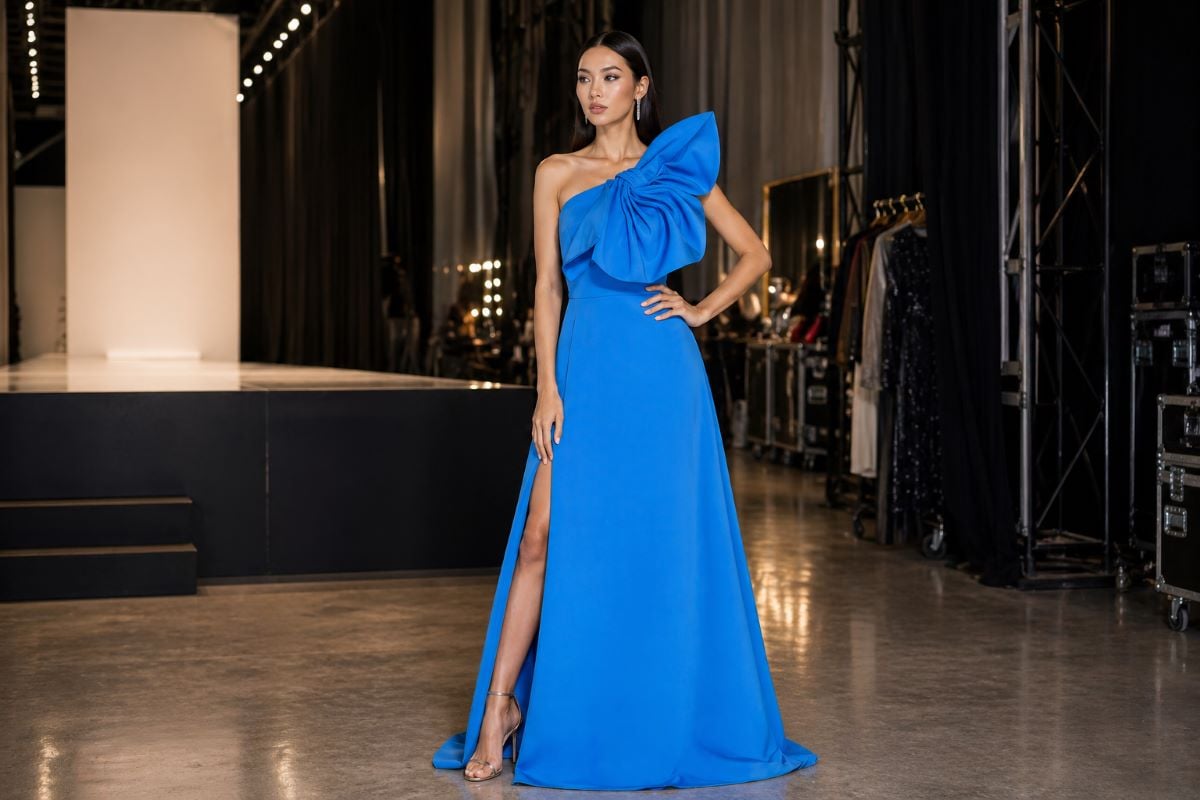 Full body blue one-shoulder evening gown with defined waist and high slit