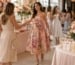 Bridal shower hostess welcoming guests in floral midi dress