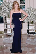 Model wearing Jovani 32929 navy strapless floor-length dress, front view.