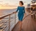 Elegant woman in teal off-shoulder cocktail dress walking