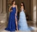 Two women in layered formal gowns with slit in a luxury interior