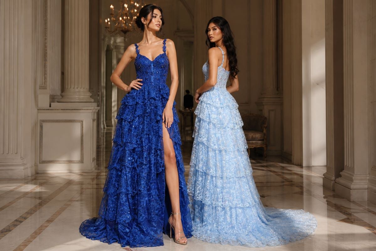 Two women in layered formal gowns with slit in a luxury interior