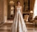 Floor-length strapless gown with gold floral embroidery in luxury interior