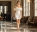 Elegant mother in cream mini dress celebrating graduation