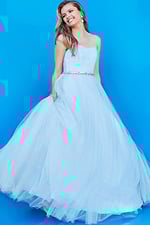 Young model wearing Jovani K66712 blue gown with delicate design.