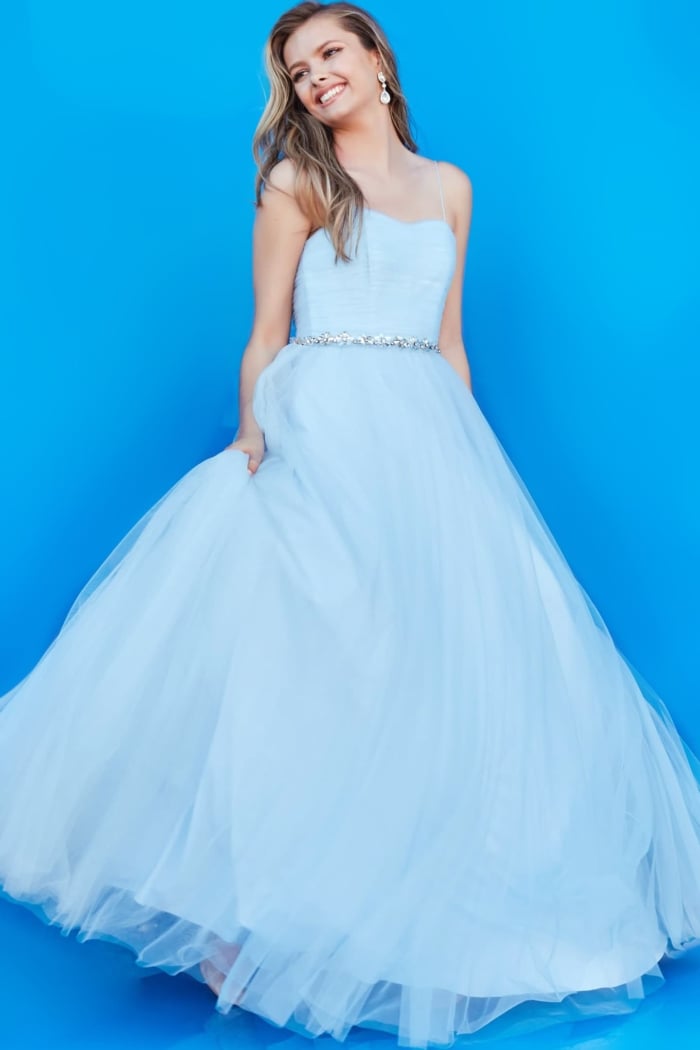 Young model wearing Jovani K66712 blue gown with delicate design.